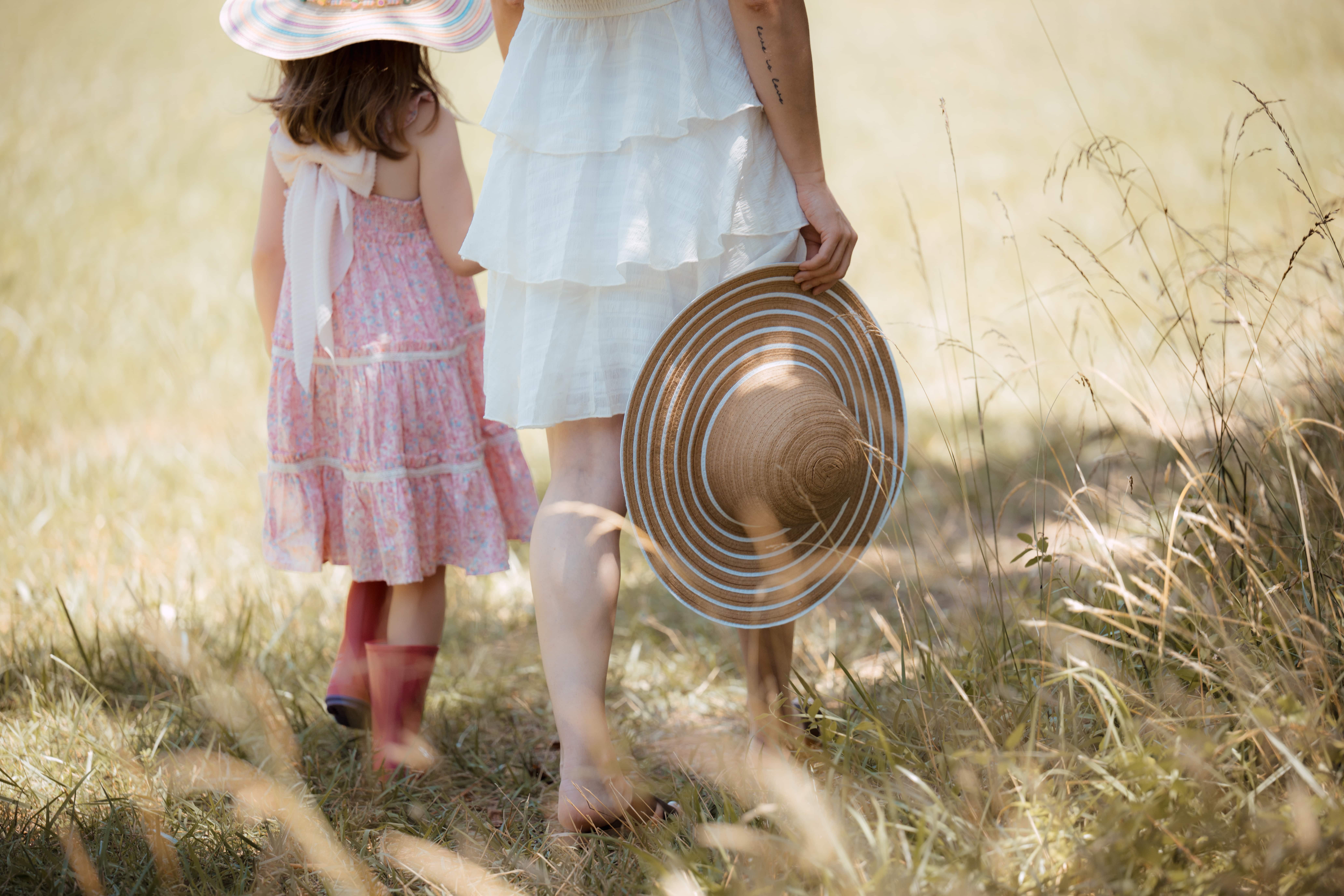 Mom and daughter walking in a field
